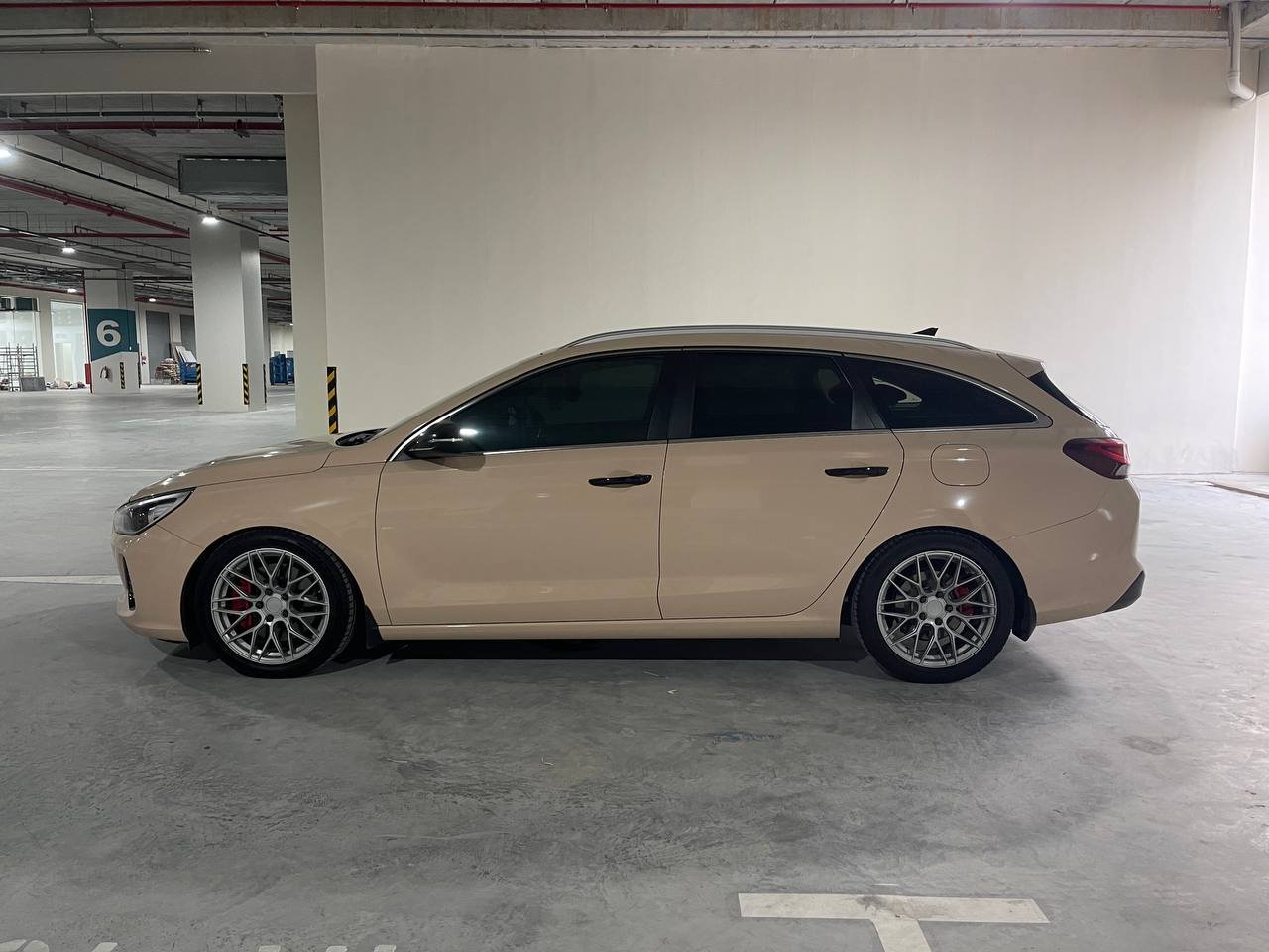 Beige Hyundai i30 wagon, side profile, parked in a garage